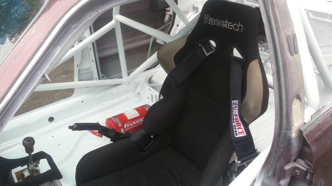 RaceTech composite seat.  The seat is on dual locking sliders, plus there is an adjustable rear seat brace on the roll cage that can be adjusted during drivers changes